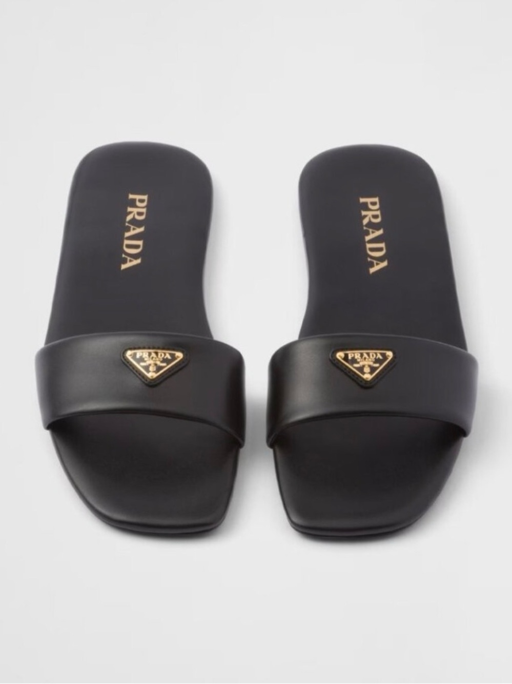 Prada Black Leather Slides with Gold Triangle Logo